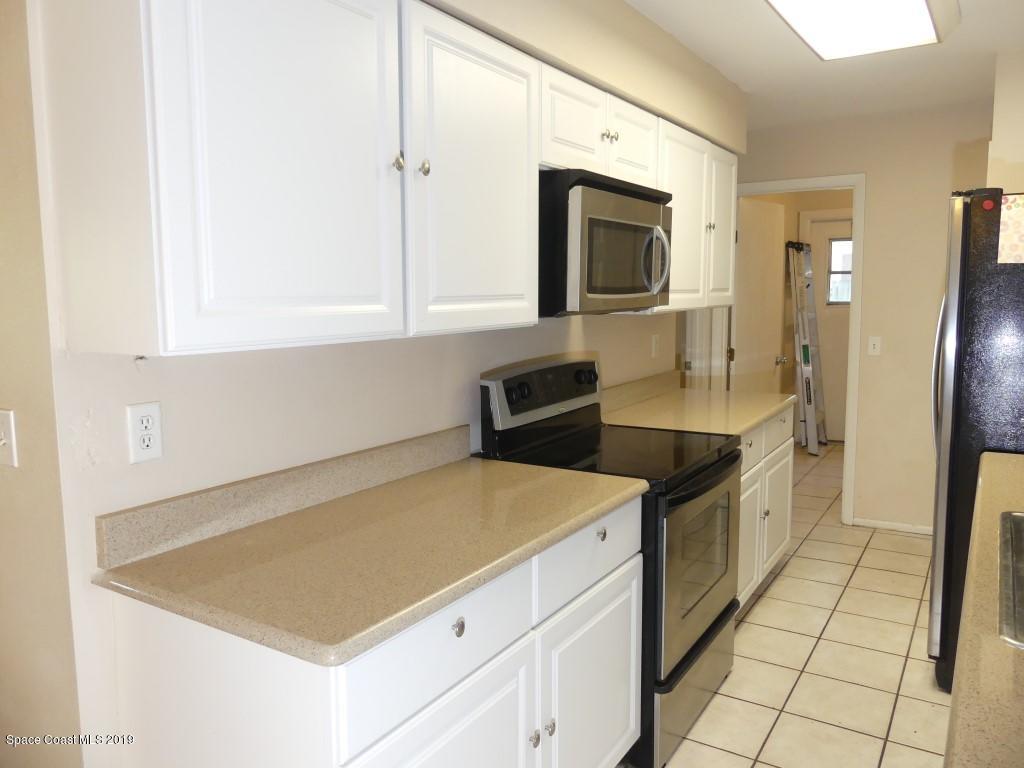 4730 Ivan Street Cocoa, FL 32927 - Photo 7 of 23 a kitchen with stainless steel appliances a stove microwave and refrigerator