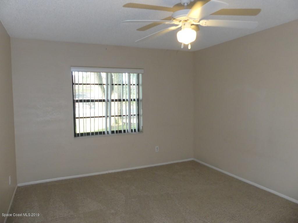 4730 Ivan Street Cocoa, FL 32927 - Photo 8 of 23 an empty room with a window and a fan