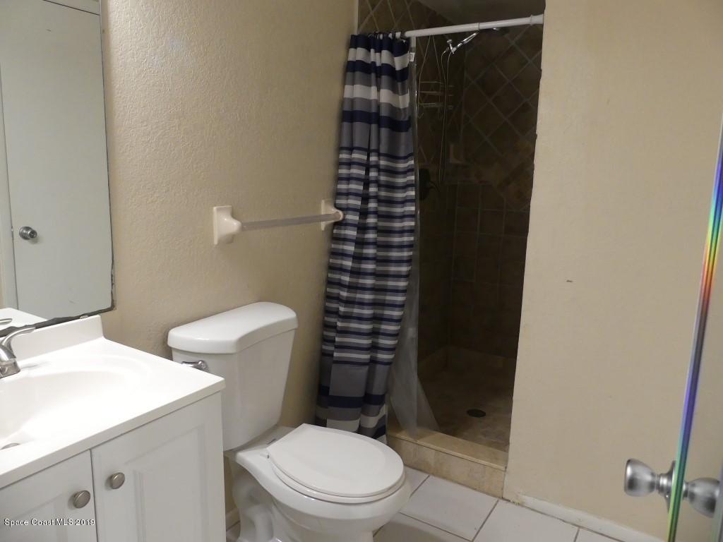 4730 Ivan Street Cocoa, FL 32927 - Photo 9 of 23 a bathroom with a shower toilet and sink