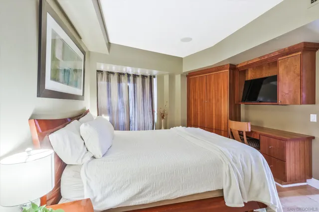 a bedroom with a bed and a flat screen tv