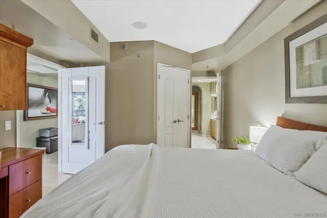 a bedroom with a bed dresser and window