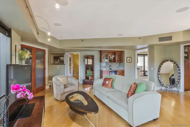 a living room with furniture and a chandelier