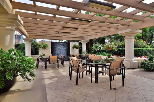 a outdoor space with lots of tables a garden and chairs
