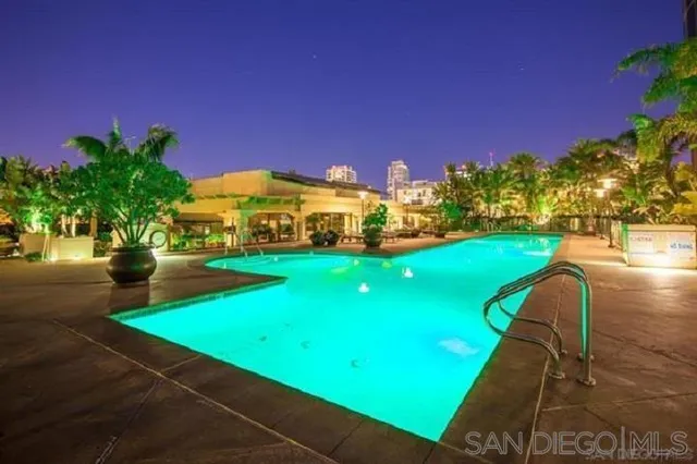 a view of a green field with house in the background