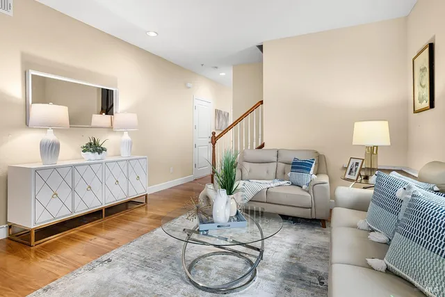 a living room with furniture a rug and a window