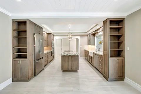 a large room with a large window and kitchen view