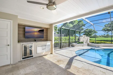 an aerial view of a house with swimming pool garden and patio
