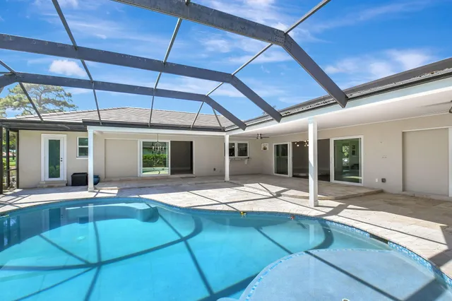 an aerial view of a house with a yard and garden