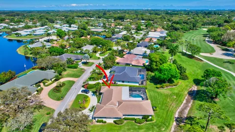 a view of a house with a yard deck and a slide