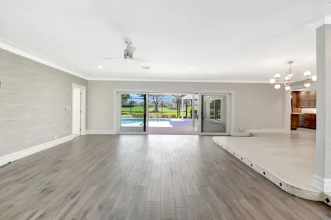 a large kitchen with kitchen island granite countertop a large window