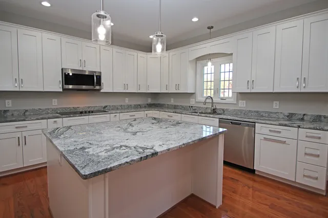 a kitchen with granite countertop white cabinets and a granite counter tops