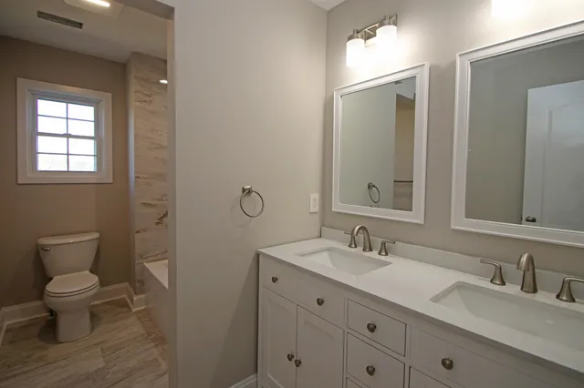 a bathroom with a toilet and a bathtub