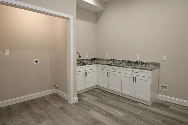 a room with a sink and a mirror