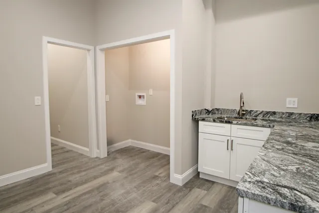 a view of a room with window and cabinet area
