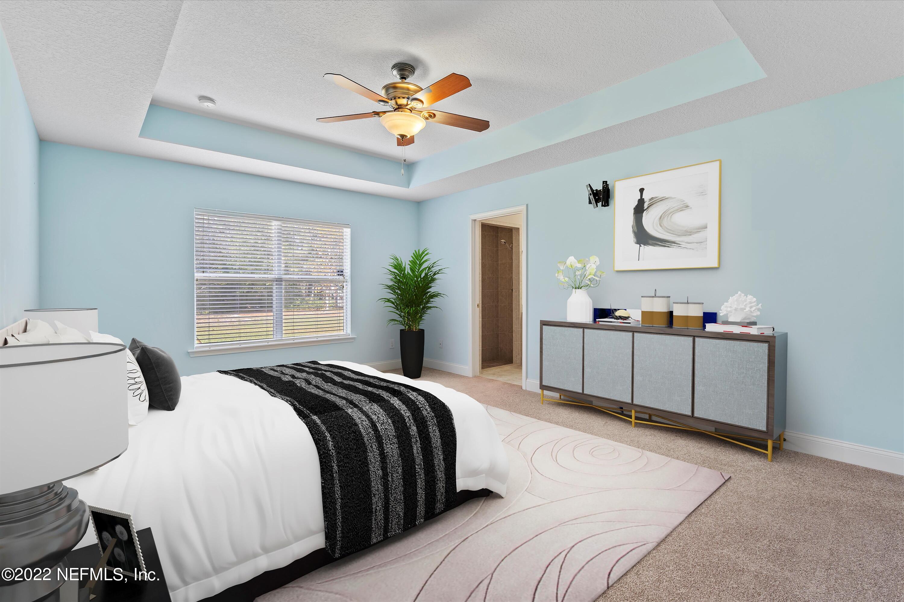 5306 Eulace Road Jacksonville, FL 32210 - Photo 12 of 30 a bedroom with a large bed and a chandelier