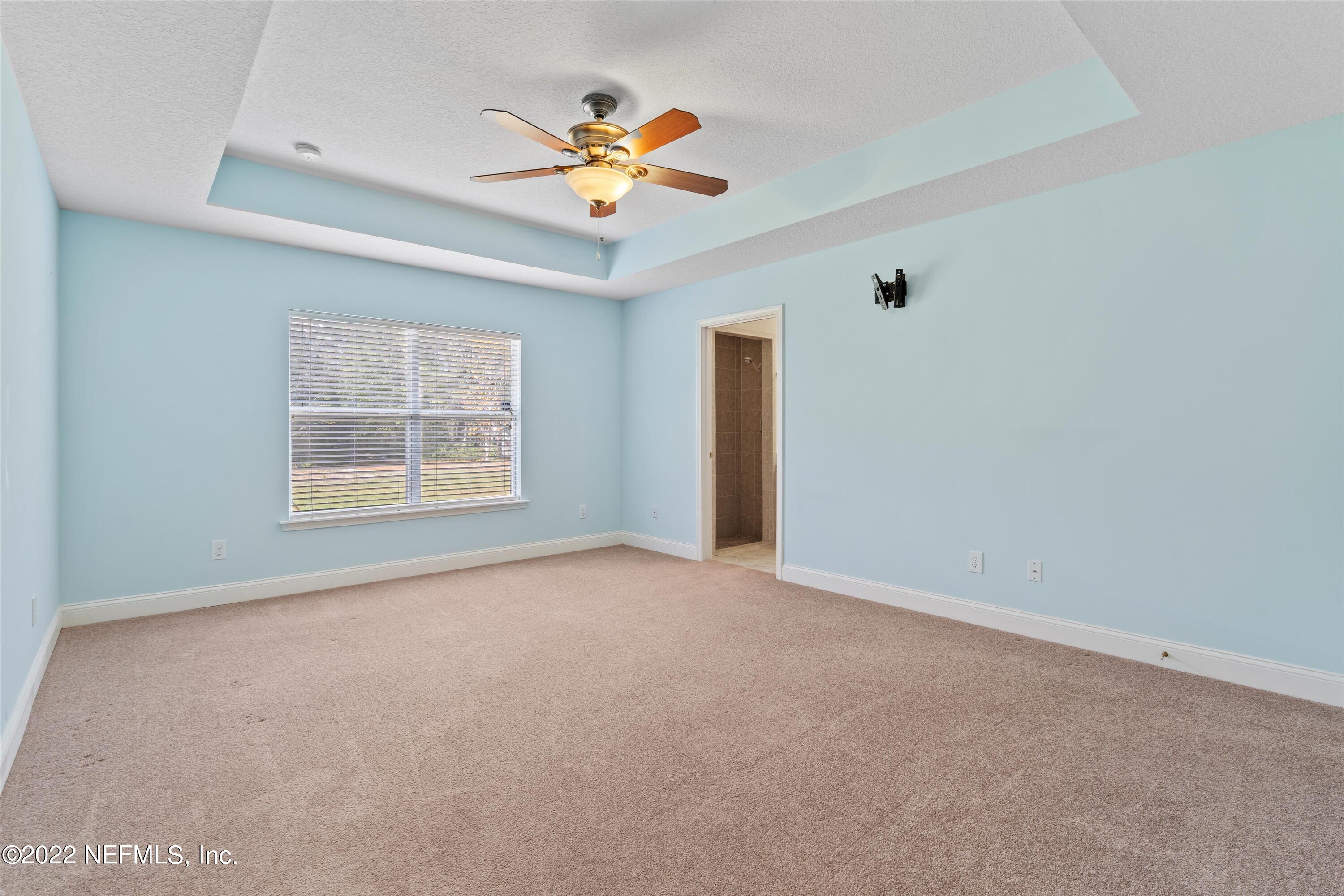 5306 Eulace Road Jacksonville, FL 32210 - Photo 13 of 30 an empty room with windows and fan