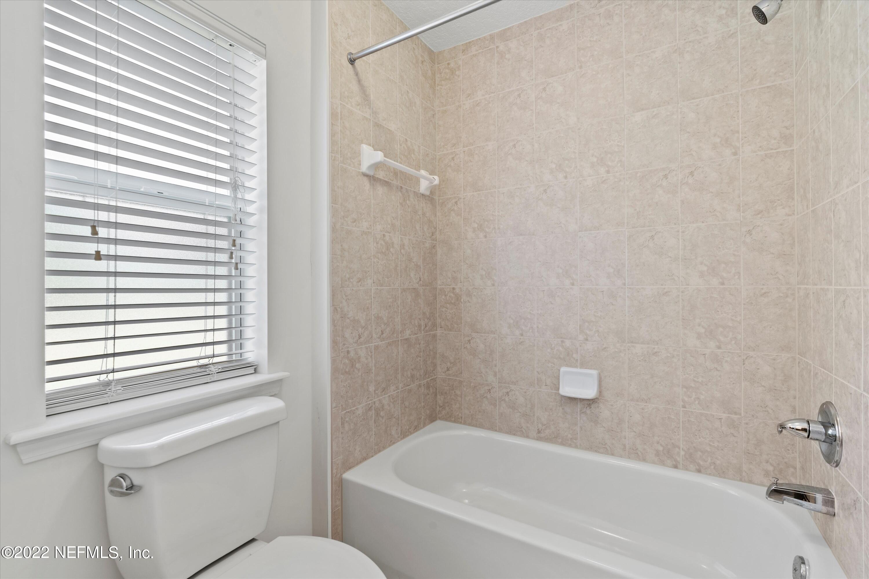 5306 Eulace Road Jacksonville, FL 32210 - Photo 16 of 30 a bathroom with a bathtub and a shower