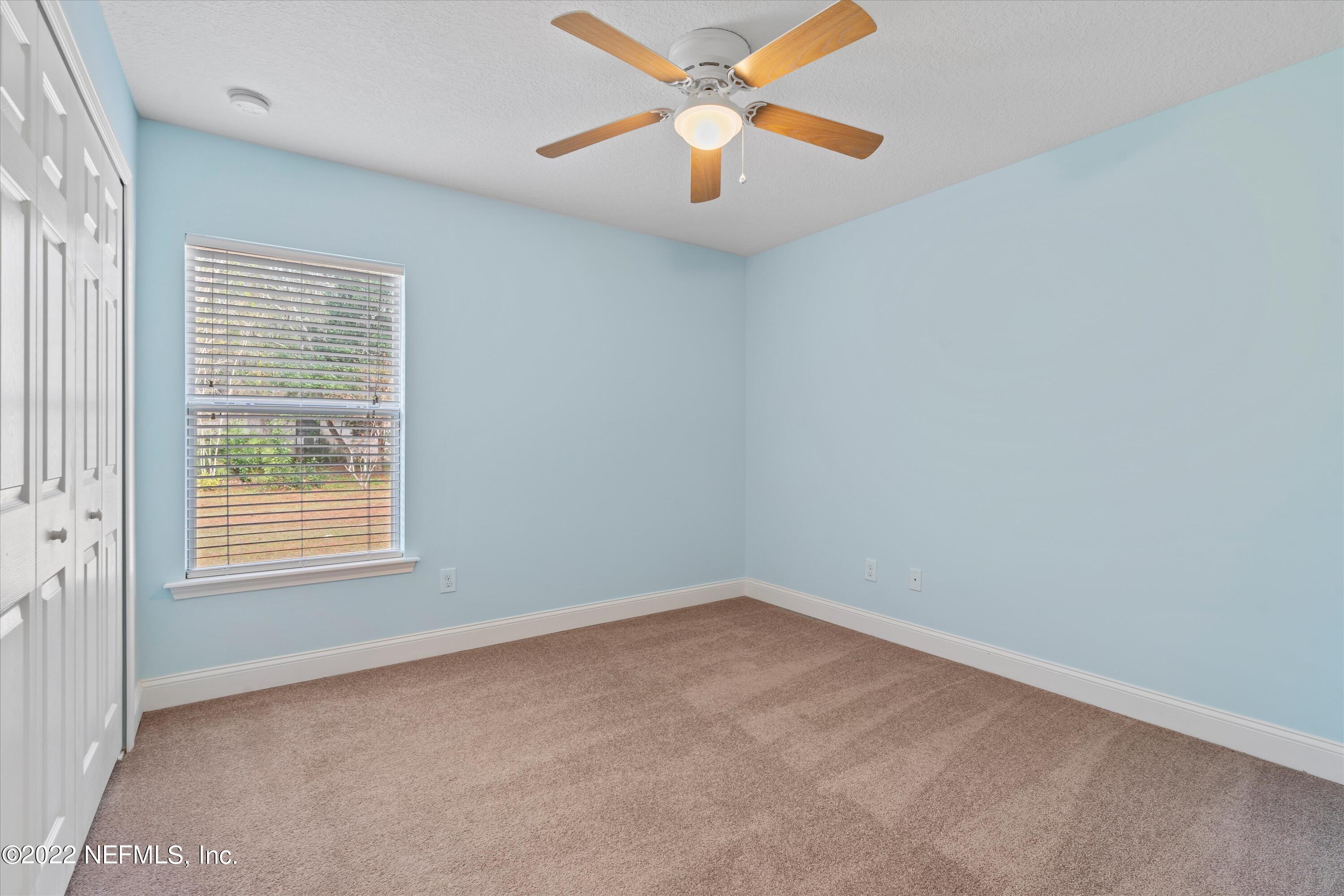 5306 Eulace Road Jacksonville, FL 32210 - Photo 17 of 30 an empty room with a window and a fan