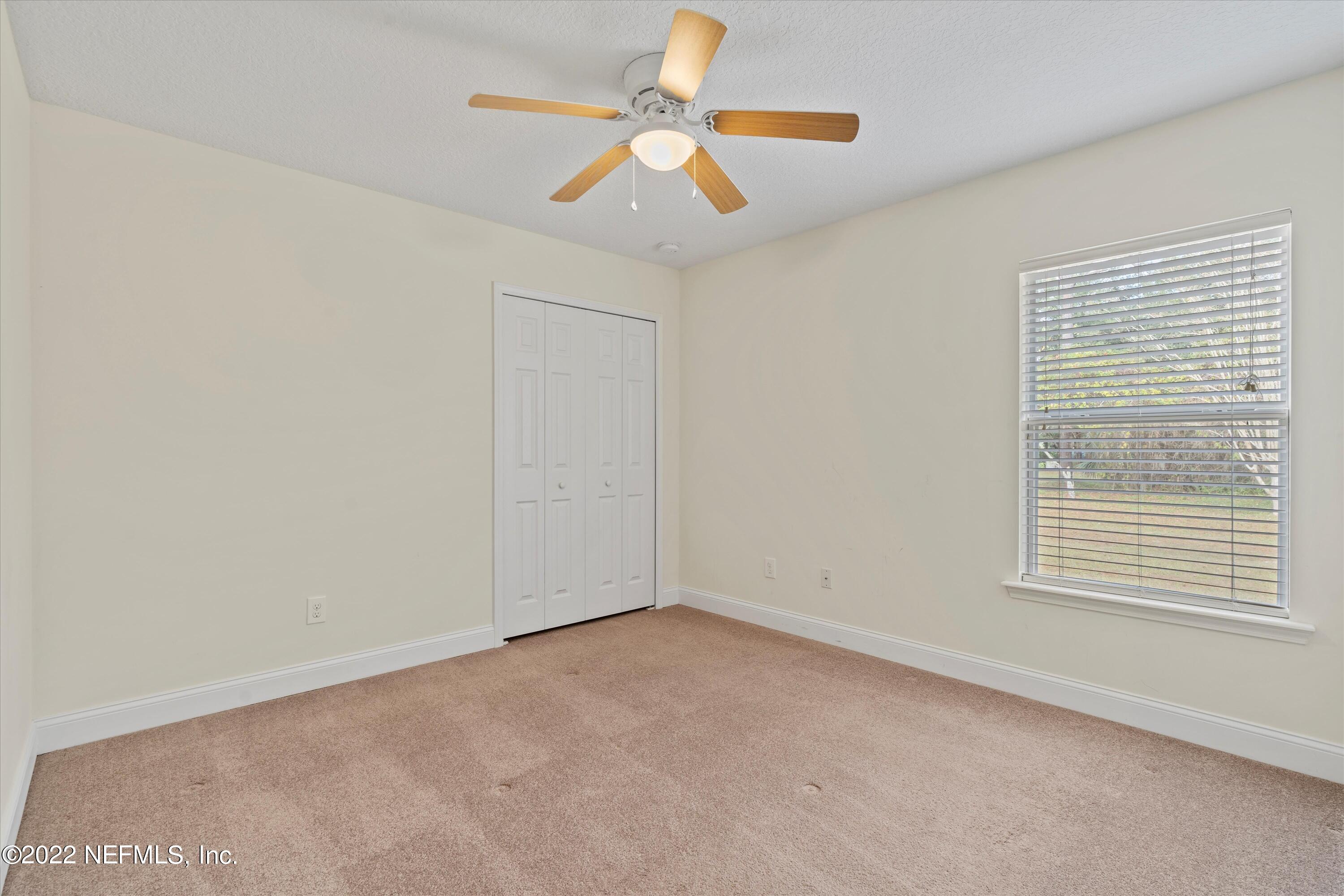 5306 Eulace Road Jacksonville, FL 32210 - Photo 18 of 30 an empty room with a window and a fan