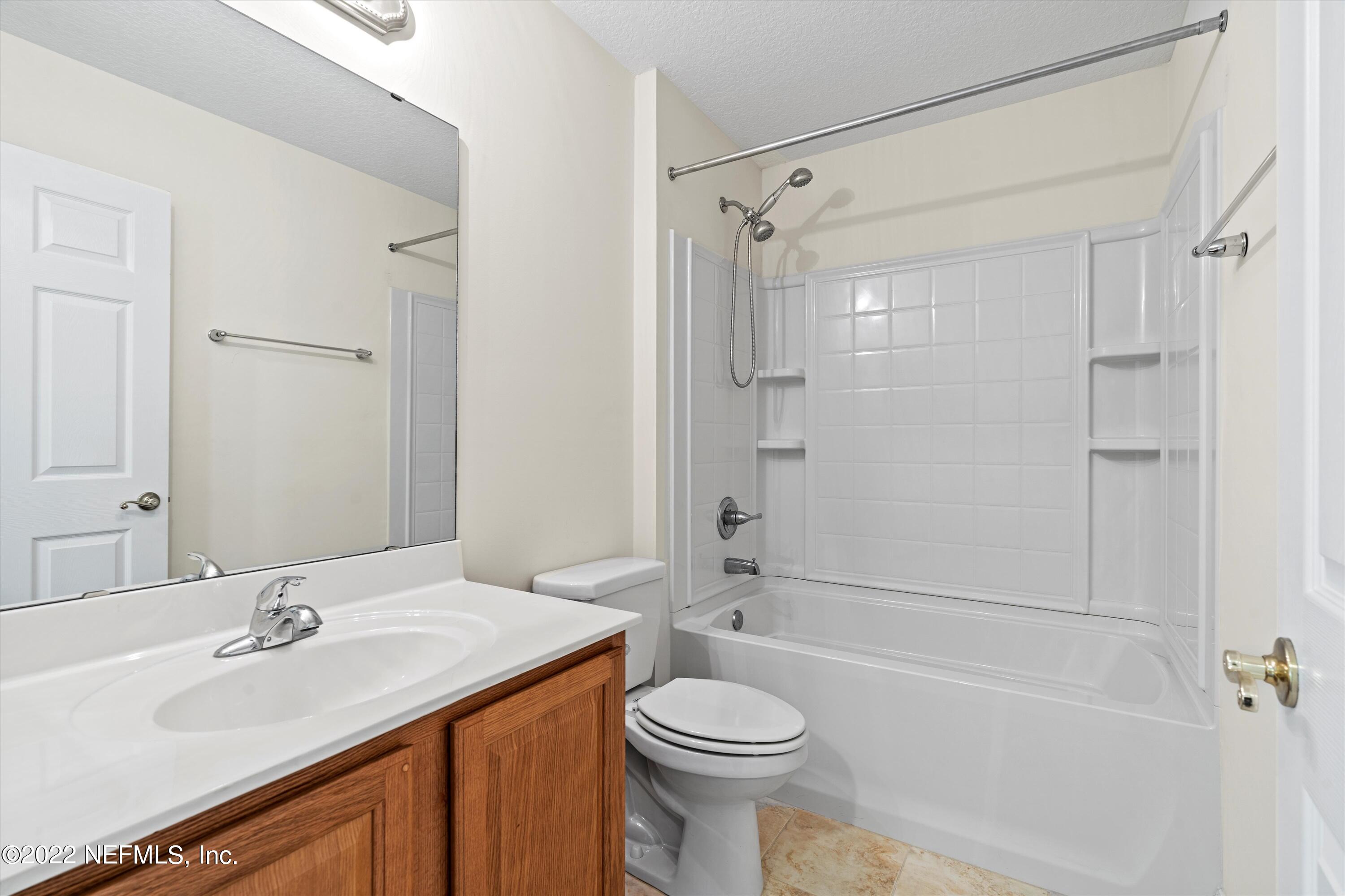 5306 Eulace Road Jacksonville, FL 32210 - Photo 19 of 30 a bathroom with a sink toilet vanity and shower
