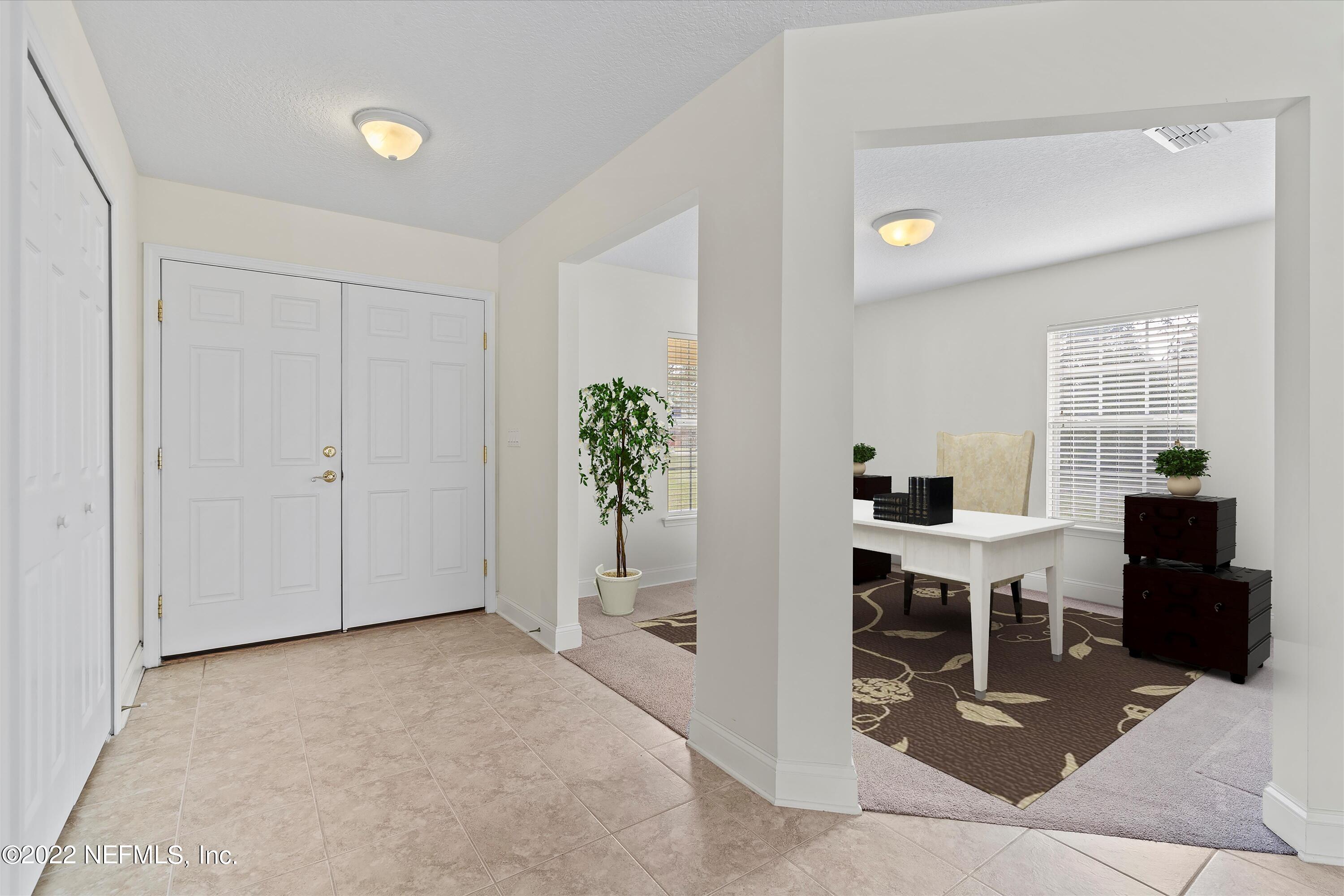 5306 Eulace Road Jacksonville, FL 32210 - Photo 4 of 30 a view of a livingroom with furniture and a potted plant