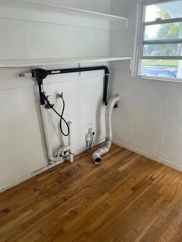 a view of a room with wooden floor and a window