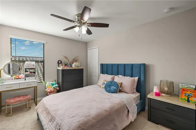 a bedroom with a bed and a dresser in it