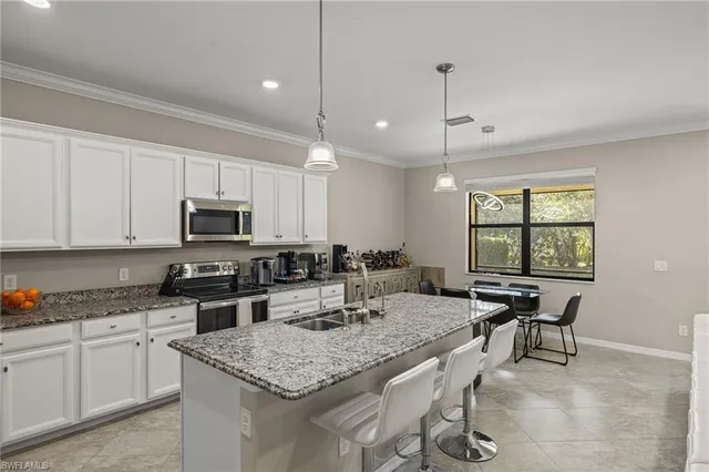 a kitchen with granite countertop lots of counter top space and dining table
