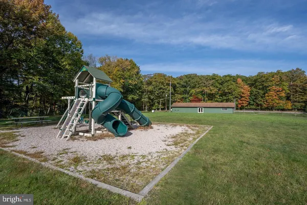 a view of outdoor space with playground and green space