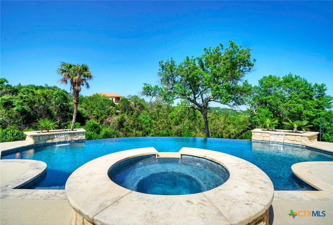 324 St Stephens School Road Austin, TX 78746 - Photo 1 of 1 a view of a swimming pool with a patio