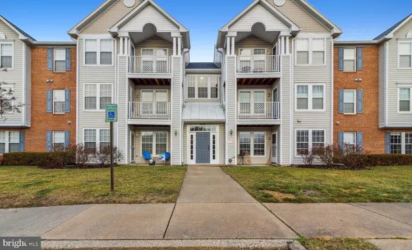 a front view of a residential apartment building with a yard