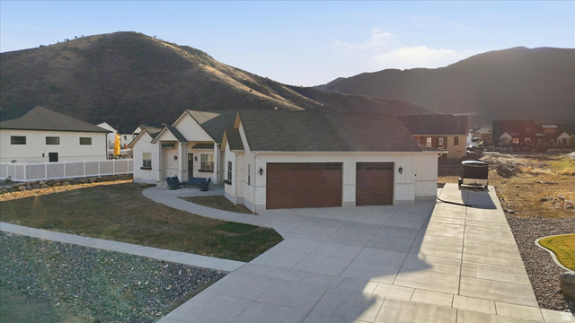 534 East Fish Hatchery Road Mantua, UT 84324 - Photo 74 of 87 View of front of property featuring an attached garage, a mountain view, and driveway