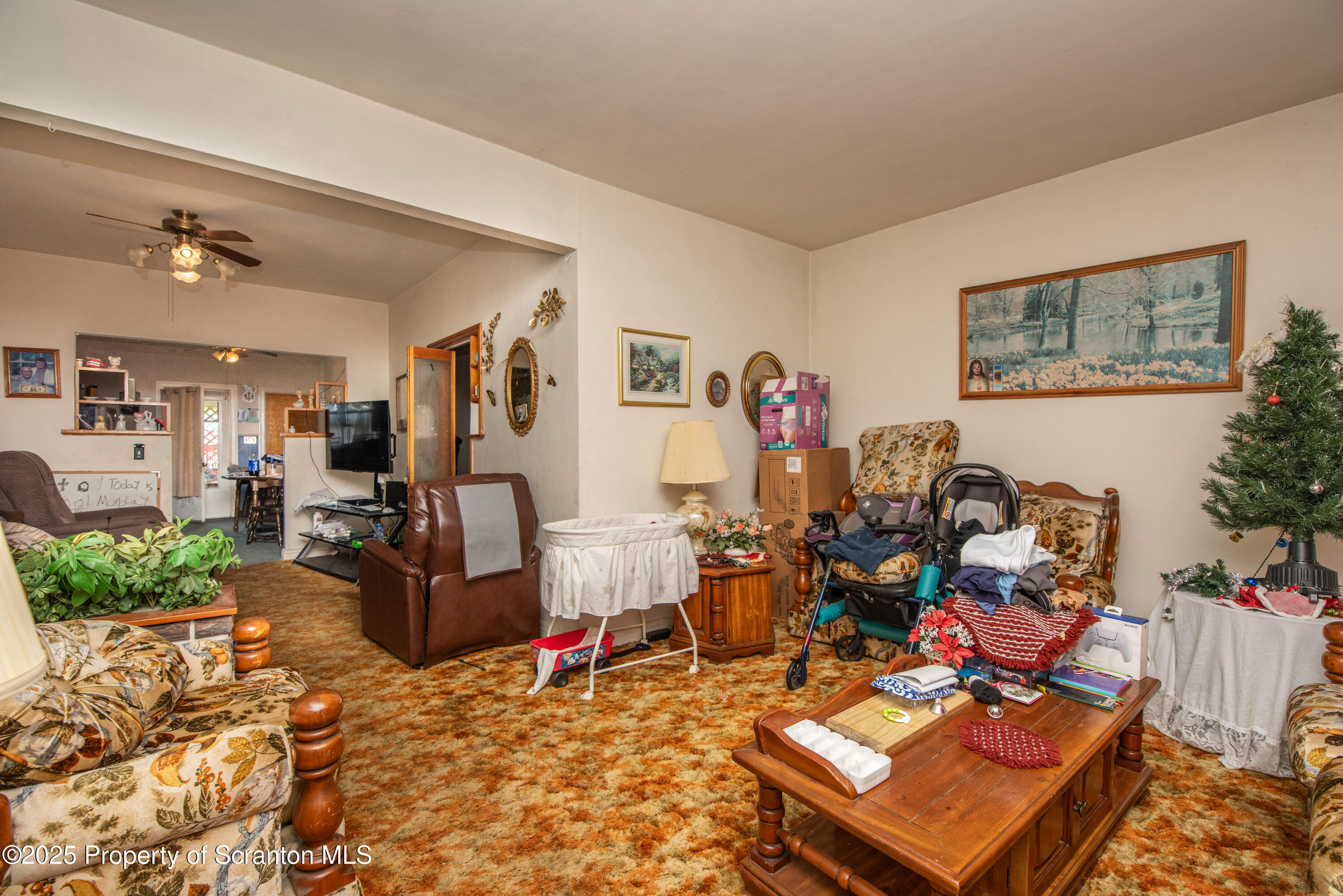 1010 Wood Street Old Forge, PA 18518 - Photo 14 of 38 a living room with lots of furniture and paintings on the wall