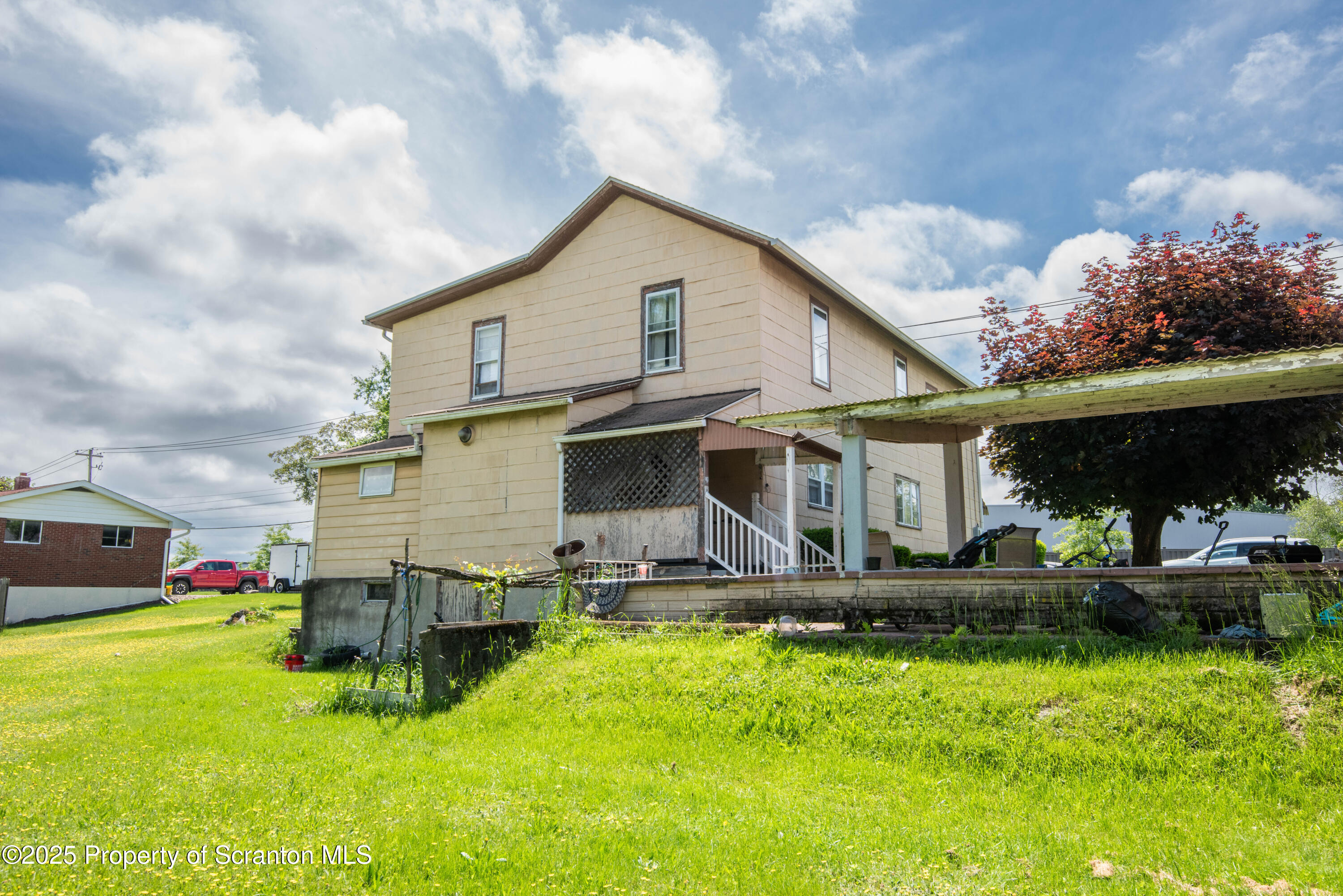 1010 Wood Street Old Forge, PA 18518 - Photo 5 of 38 a front view of a house with a yard table and chairs