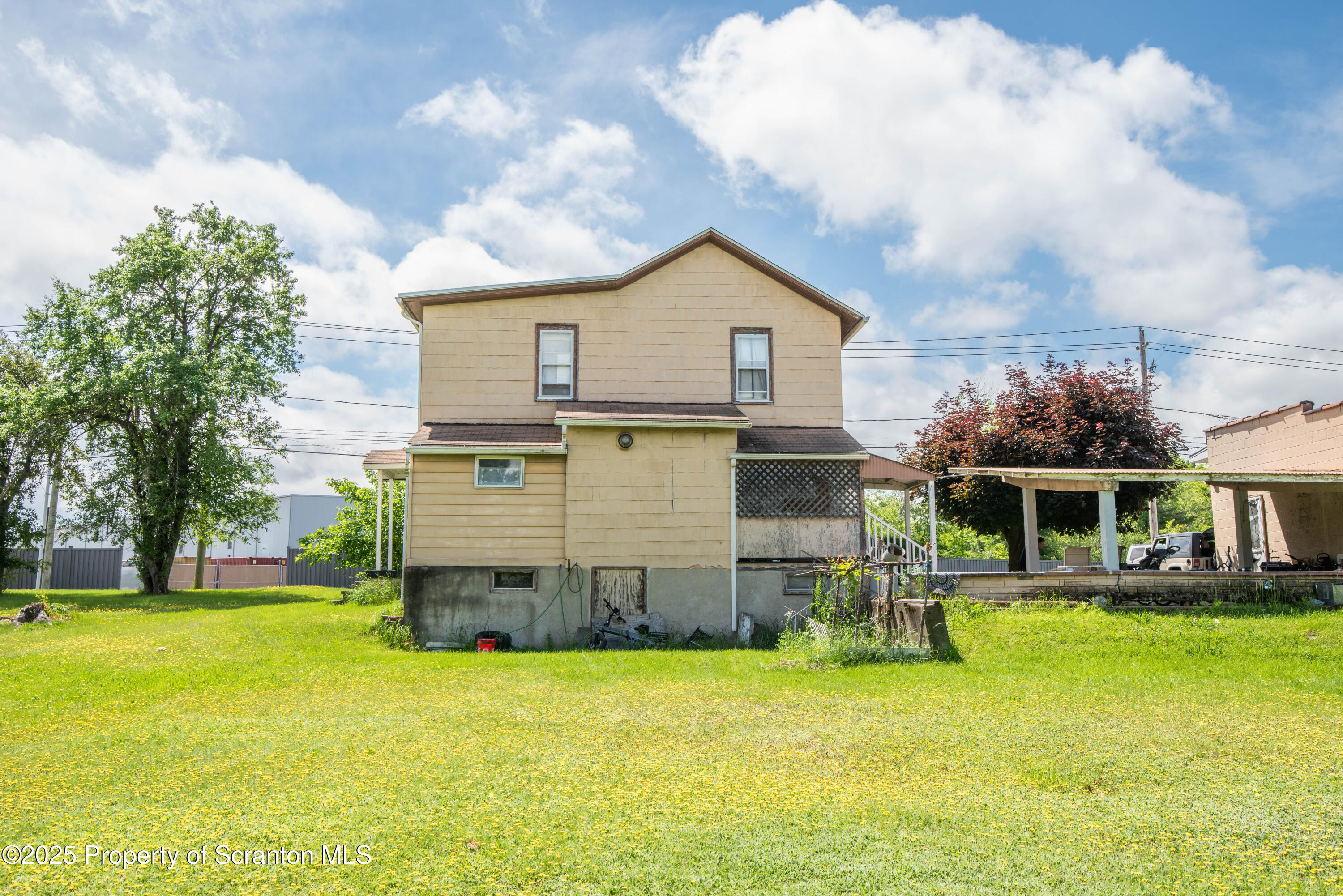 1010 Wood Street Old Forge, PA 18518 - Photo 10 of 38 a view of a big house with a big yard and large trees