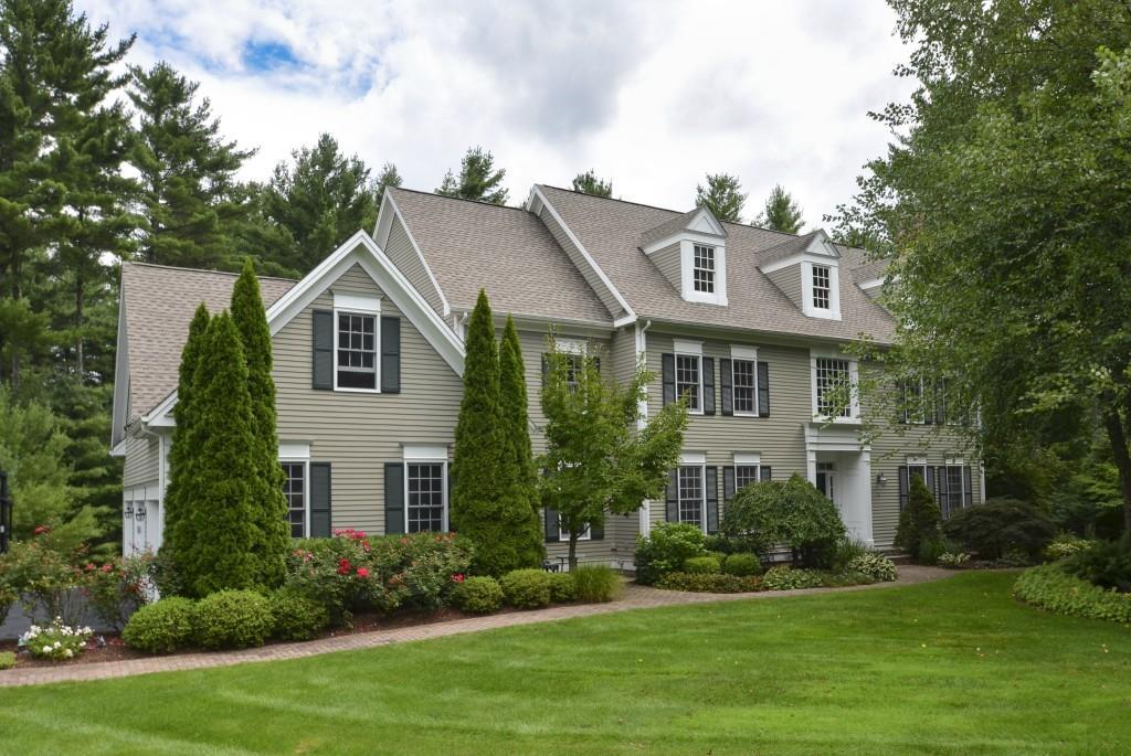 4 Brook Ridge Simsbury, CT 06092 - Photo 1 of 1 a front view of a house with a yard and trees