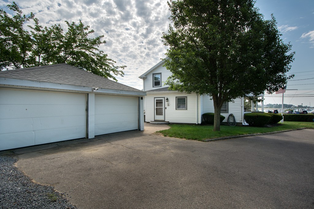 65 Jericho Road Scituate, MA 02066 - Photo 12 of 26 a view of a house with a yard and garage