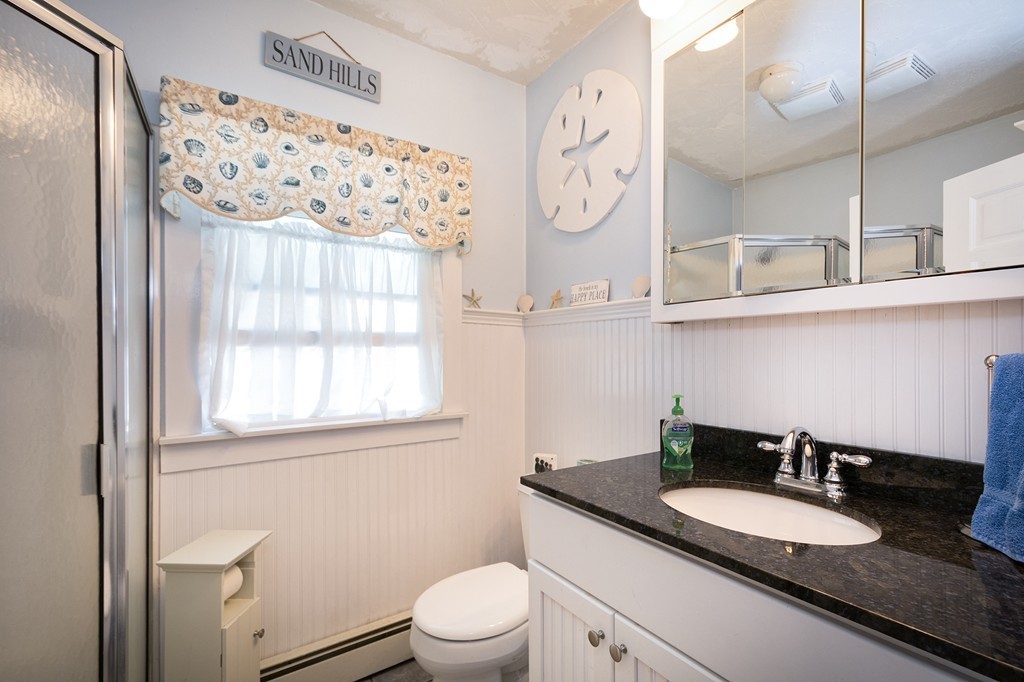 65 Jericho Road Scituate, MA 02066 - Photo 23 of 26 a bathroom with a granite countertop sink mirror vanity and toilet