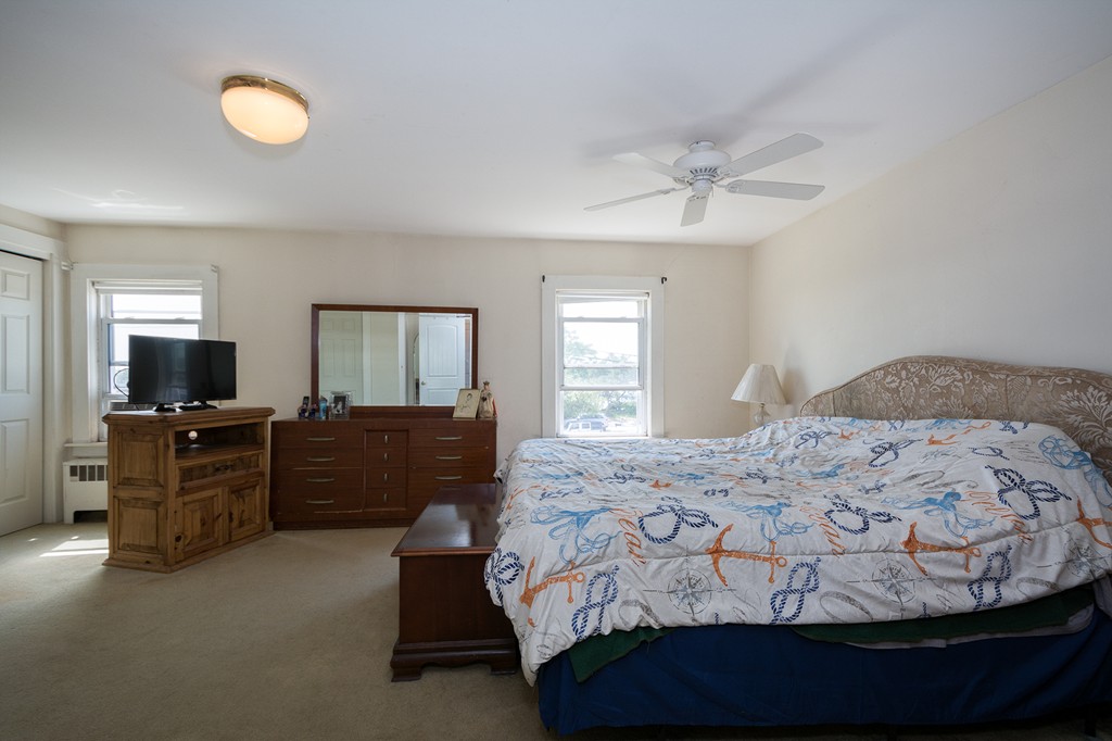65 Jericho Road Scituate, MA 02066 - Photo 26 of 26 a bedroom with a bed and wooden floor