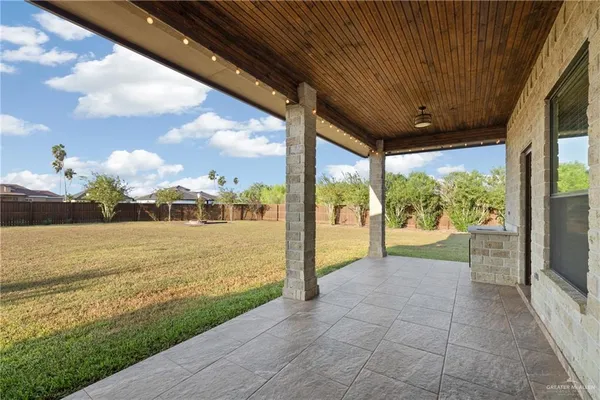 a view of a swimming pool with a patio and a garden