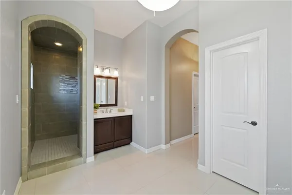 a bathroom with a tub double sink and mirror