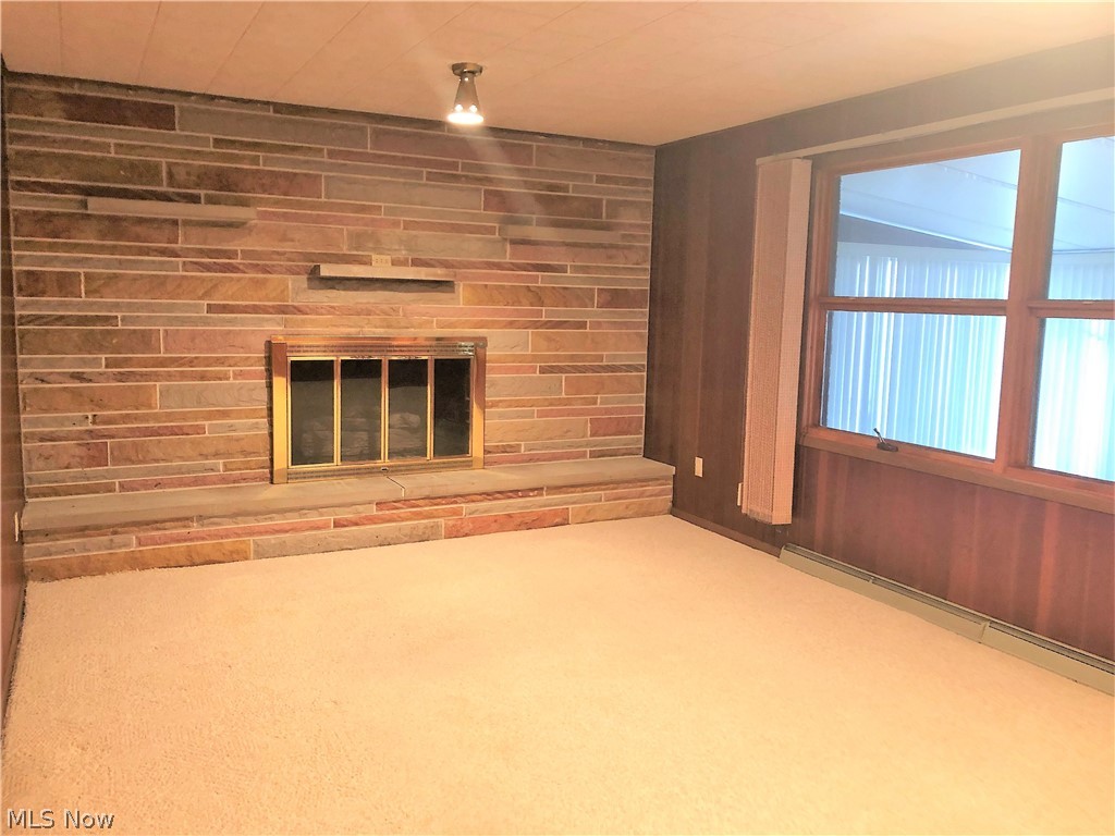 587 West Nimisila Road Akron, OH 44319 - Photo 12 of 35 Cozy Family room and view into enclosed porch to the right.