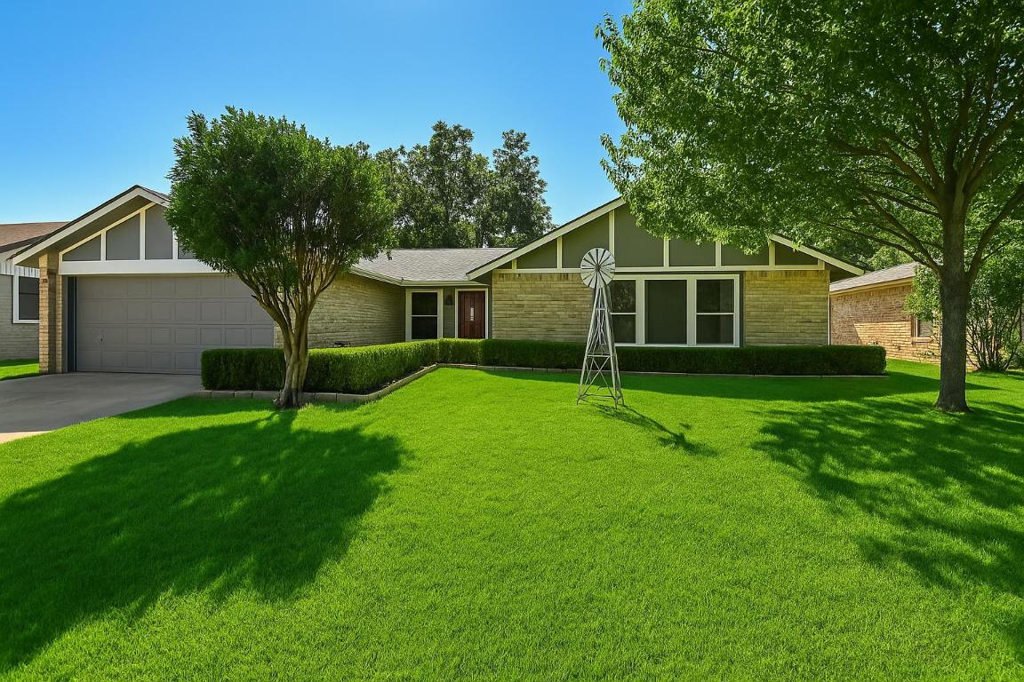 703 Windsor Road Round Rock, TX 78664 - Photo 1 of 1 a view of a house with a yard and a large tree