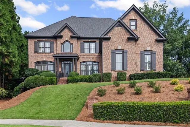 a front view of a house with a garden