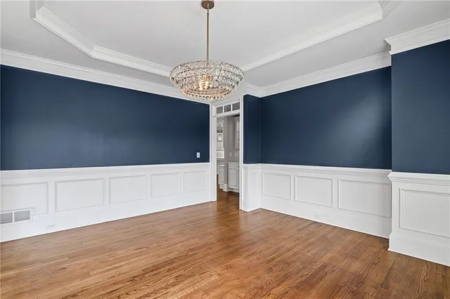 a bedroom with a large bed and windows