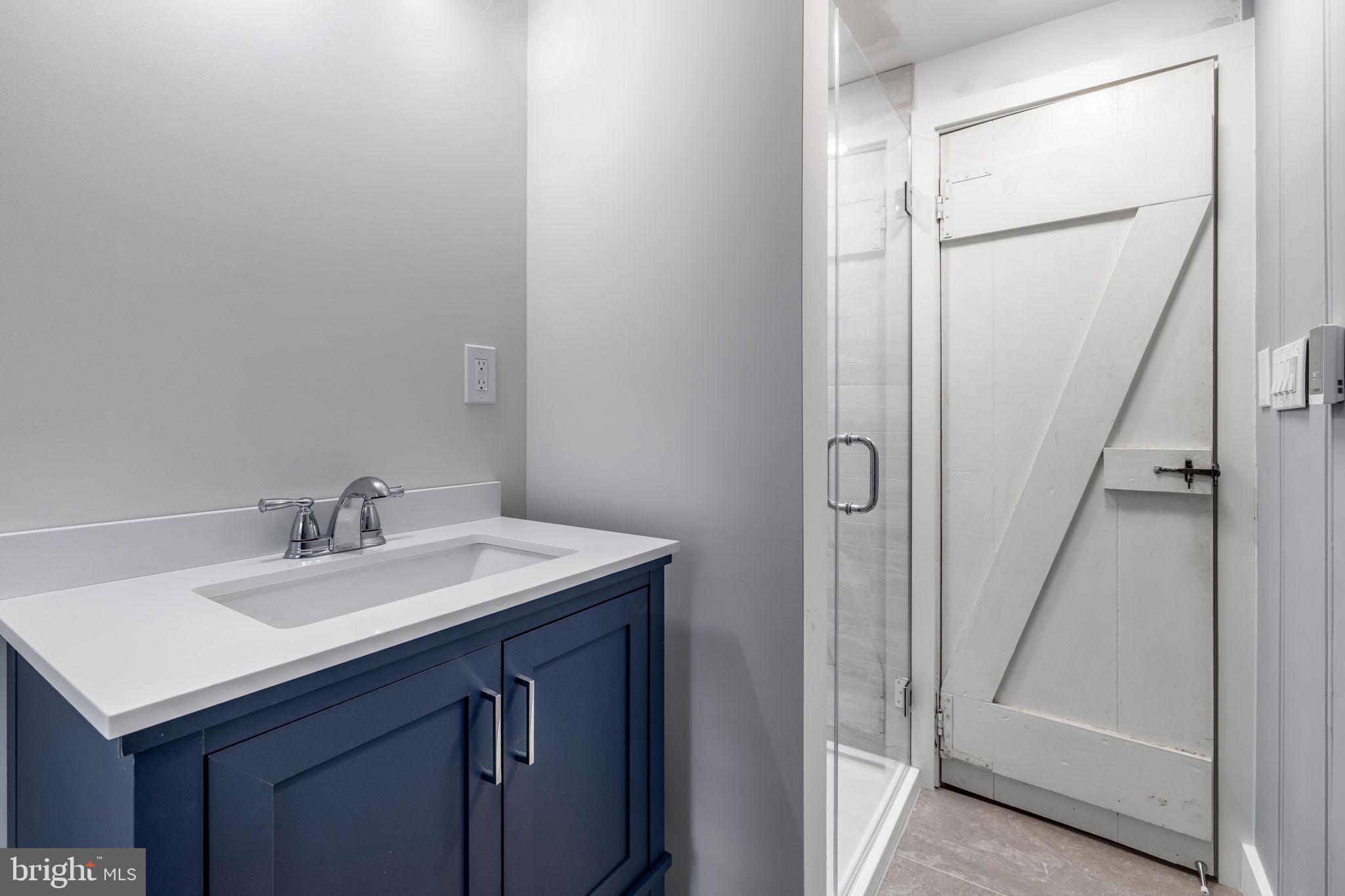 765 Dividing Road Severna Park, MD 21146 - Photo 11 of 17 a bathroom with a sink and a mirror