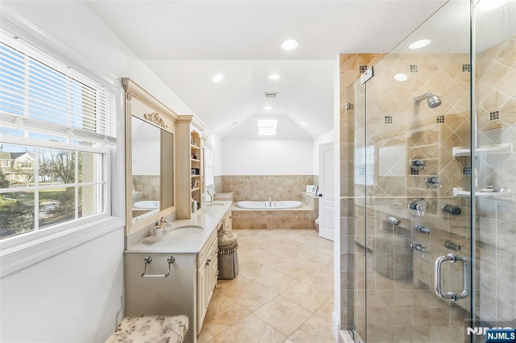 27 Pine Hill Road Old Tappan, NJ 07675 - Photo 39 of 50 a bathroom with a tub sink shower and mirror
