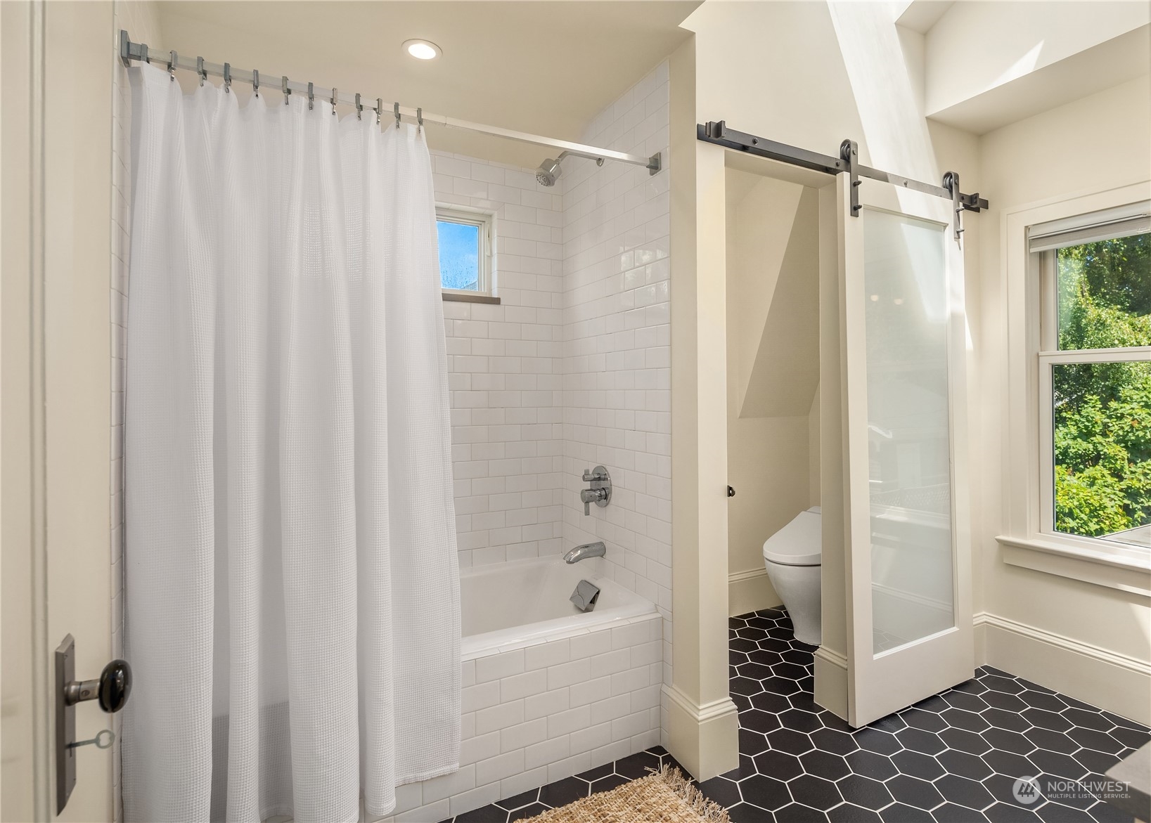 2536 1st Avenue West Seattle, WA 98119 - Photo 18 of 27 a bathroom with a shower curtain a sink and a toilet