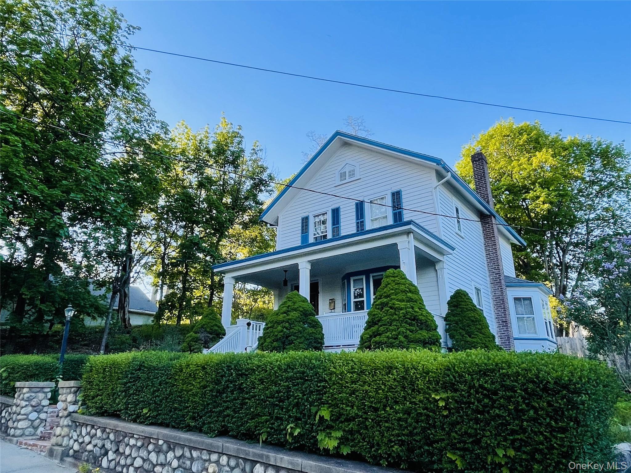 12 Parrott Street Cold Spring, NY 10516 - Photo 1 of 18 View of front of house with covered porch and stone wall
