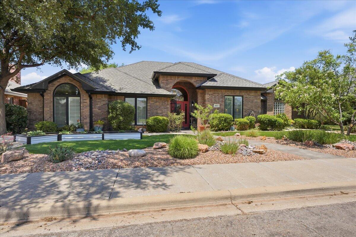 4612 100th Street Lubbock, TX 79424 - Photo 2 of 55 a front view of a house with garden